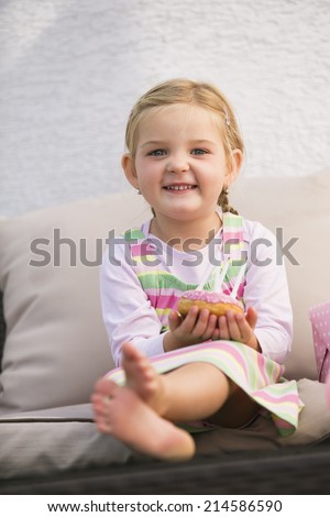 Young girl sitting on couch smiling
