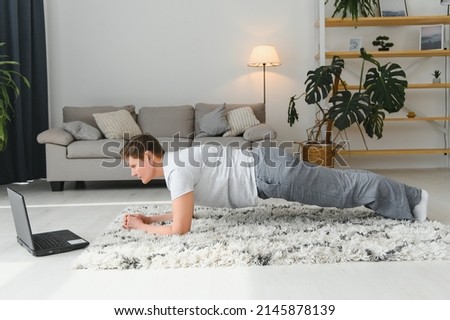 Middle age woman smiling happy doing exercise and stretching at home.