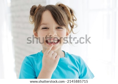 The kid lost a tooth. Baby without a tooth. Portrait of a little girl no tooth. High quality photo Royalty-Free Stock Photo #2145885715
