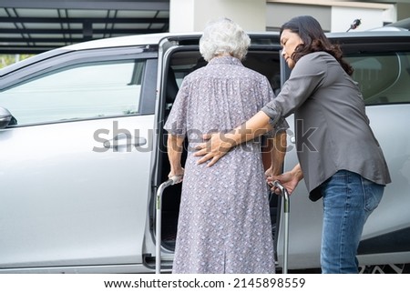 Caregiver help and support asian senior or elderly old lady woman patient walk with walker prepare get to her car, healthy strong medical concept. Royalty-Free Stock Photo #2145898559