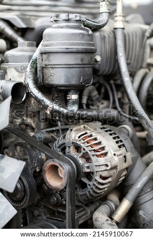 Car Generator with Drive Belt on a Car Engine