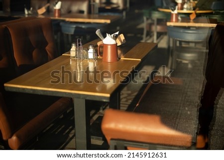 Table in restaurant. Place to relax. Brown sofa. Dining table. Empty spaces.