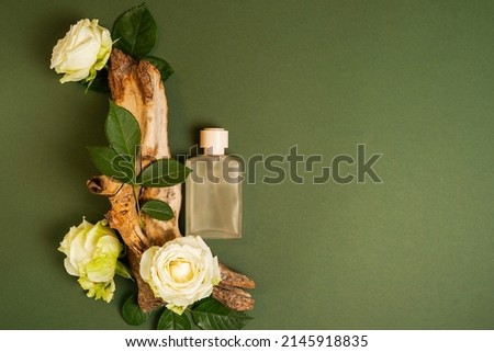 Perfume on tree bark with flowers roses on green background with copy space. concept of freshness and naturalness. the aroma of wood Royalty-Free Stock Photo #2145918835