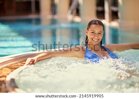 Take time for yourself. Shot of a young woman relaxing in the pool at a spa. Royalty-Free Stock Photo #2145919905