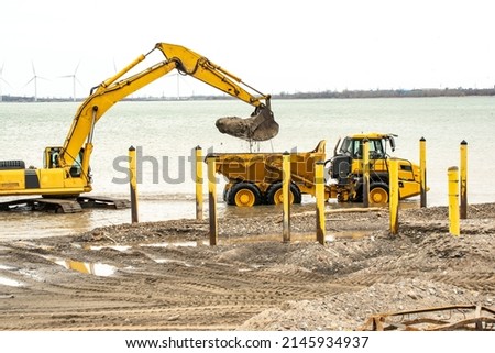 Backhoe Dredging of Shoreline for Boat Launch Royalty-Free Stock Photo #2145934937