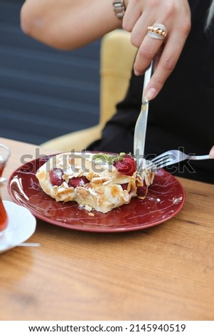 Board with delicious cake on table