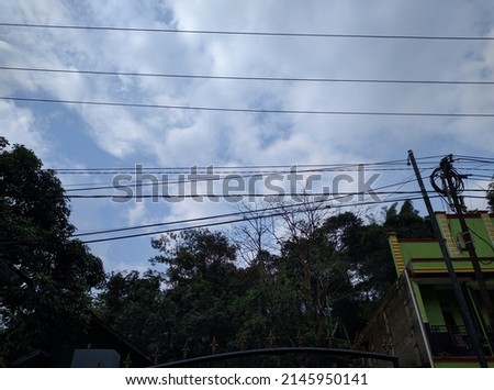 photo of telecommunications cables and power lines on a white cloud background