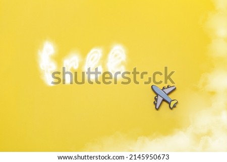 Toy plane and inscription free on a yellow background