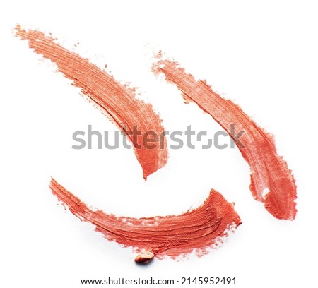 Lipstick smear smudge swatch isolated on white background. Cream makeup texture.