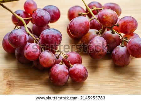 Fresh grapes on wooden background. Selective focus with shallow depth of field.