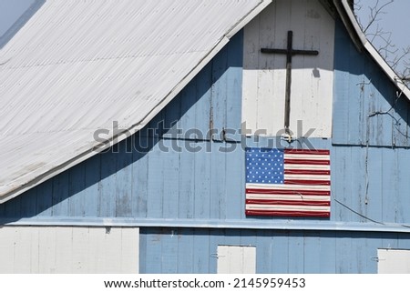 Cross and American flag on a barn