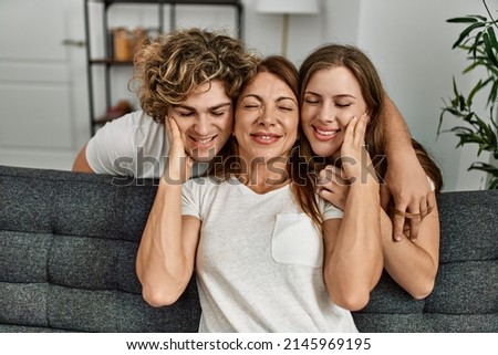 Mother and couple smiling confident and kissing at home
