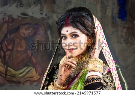 Portrait of a beautiful young Indian woman in traditional clothing and Indian accessories.