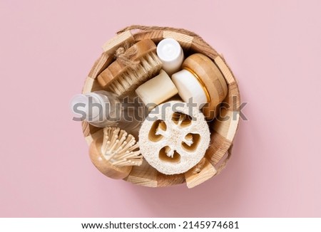 Sauna bucket with organic natural cosmetics and zero waste reusable accessories for skin and hair care on pink. Top view of eco friendly beauty products for bath, massage or spa salon Royalty-Free Stock Photo #2145974681