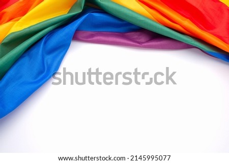Top view of the rainbow flag or LGBT over a white background with copy space for text. Flat lay Royalty-Free Stock Photo #2145995077