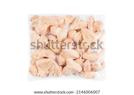 Industrial chicken selling and producing.Raw, frozen Chicken wings in a transparent package on an isolated white background.Top view.Copy space.
