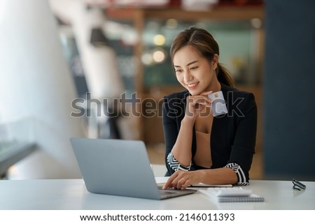 Young Asian business woman using smartphone and credit card for online shopping. Online Payment.