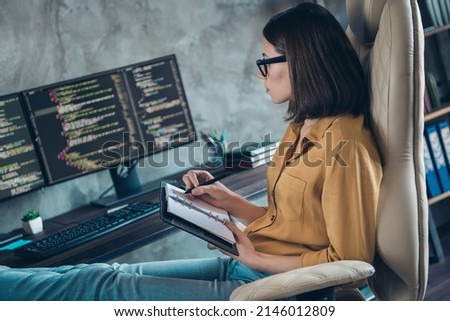 Profile side view portrait of attractive focused smart clever girl skilled editor writing plan php interface at workplace workstation indoors