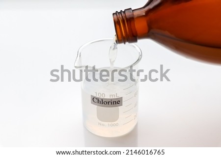 chlorine solution in glass, Chlorine is used to kill bacteria or to perform experiment in laboratory  Royalty-Free Stock Photo #2146016765