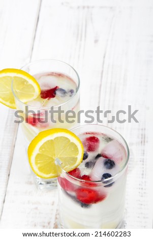 mineral water with fruit frozen in ice cubes - a refreshing drink
