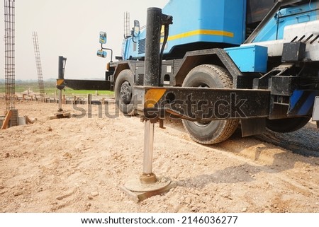 hydraulics crane support is on the ground at the construction site. Royalty-Free Stock Photo #2146036277