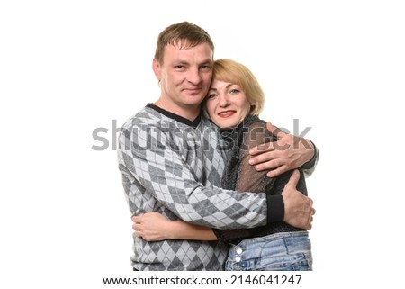 Man and woman hugging and looking into the frame, isolated on a white background