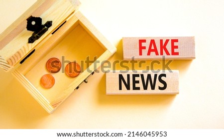 Fake news symbol. Wooden blocks with concept words Fake news on beautiful white background. Wooden chest with coins. Business media and fake news concept. Copy space.