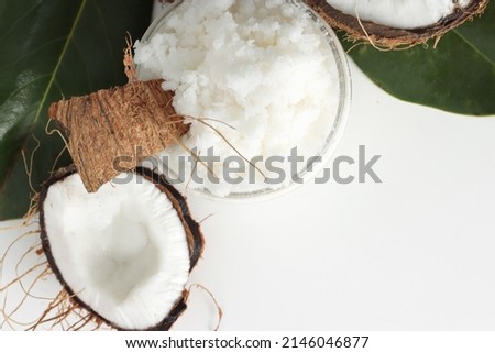 Full jar with coconut scrub on white background. Home spa treatment concept, organic cosmetic. Copyspace