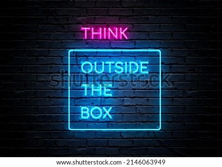 Pink and blue neon sign motivational quote with brick wall background. Think outside the box.