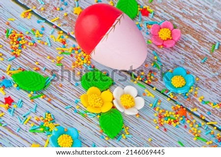 Beautiful bright  easter composition with eggs and sweets, colorful sugar icing flowers 