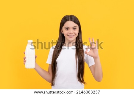 happy child hold dairy beverage product. teen girl going to drink milk. healthy lifestyle Royalty-Free Stock Photo #2146083237