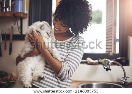Arent you the cutest. Shot of a young woman enjoying a cuddle with her cat. Royalty-Free Stock Photo #2146083755
