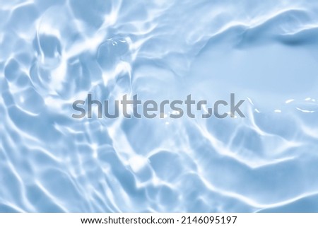 Splash cosmetic moisturizer water micellar toner or emulsion blue colored abstract background Royalty-Free Stock Photo #2146095197