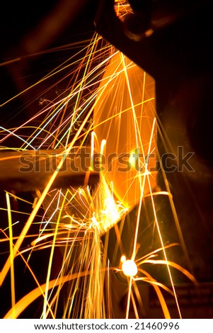 Photo of white hot sparks at grinding steel material