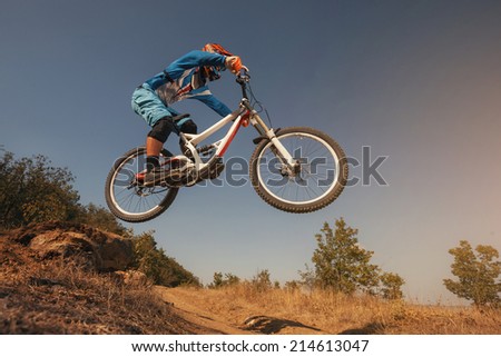 Mountain Bike cyclist jumping. Downhill biking. Extreme sports cycling.