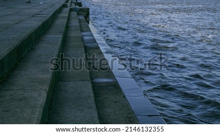 Bank of the Dnieper River. Waves hit the rocky shore. Water waves background