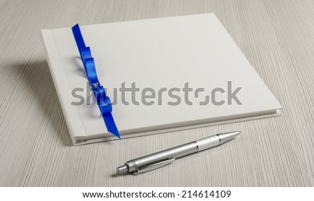 White decorated wedding guest book on the bright table
