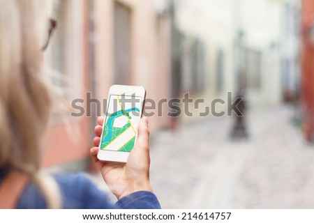 Tourist using navigation app on the mobile phone.