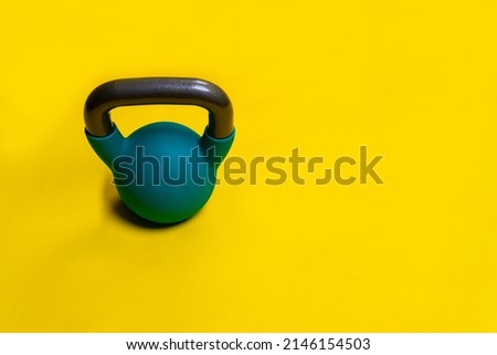 A background yellow text for Kettlebell space Blue with on isolated fitness, for fit health from black for healthy lifestyle, weight color. Vivid pound hand, steel retro athletic strong