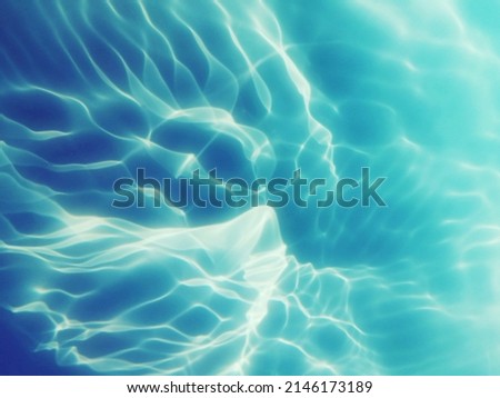 Reflection​ on​ surface​ blue​ water​ in​ the​ sea. Abstract​ of​ surface​ blue​ water​ for​ background. Closeup​ abstract​ of​ surface​ blue​ water pattern​. Splash​ed​ water​ in the​ swimming  pool.