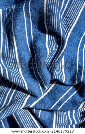 Blue Striped Background .Soft fabric with white and blue stripes .White and blue striped fabric texture with creased folds . Royalty-Free Stock Photo #2146179219