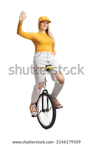 Young female on a unicycle waving at camera isolated on white background Royalty-Free Stock Photo #2146179509