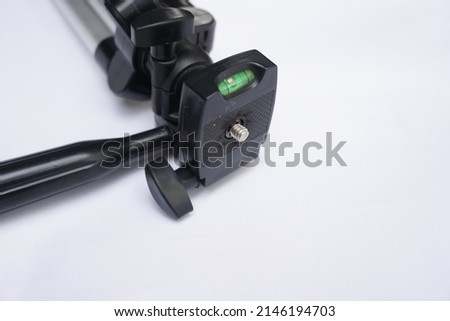 tripod for photographers and videographers during outdoor projects. tripod close-up isolated on white