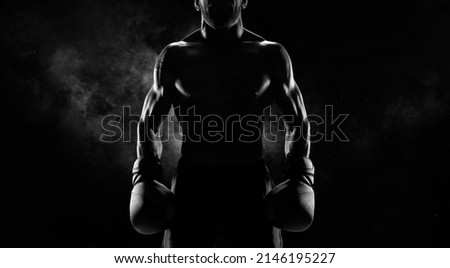 Noname image of a kickboxer on a dark background. The concept of mixed martial arts. MMA Royalty-Free Stock Photo #2146195227