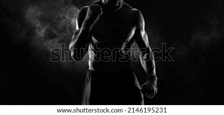 Noname image of a kickboxer on a dark background. The concept of mixed martial arts. MMA Royalty-Free Stock Photo #2146195231