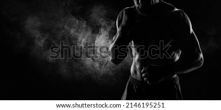 Noname image of a kickboxer on a dark background. The concept of mixed martial arts. MMA Royalty-Free Stock Photo #2146195251