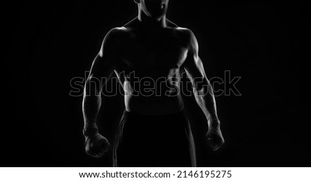 Noname image of a kickboxer on a dark background. The concept of mixed martial arts. MMA Royalty-Free Stock Photo #2146195275