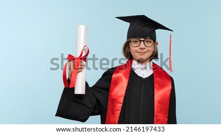 Whizz kid 9-11 year girl wearing graduation cap, round eyewear and ceremony robe with certificate diploma on light blue background. Graduate celebrating graduation. Education Concept. Success Royalty-Free Stock Photo #2146197433