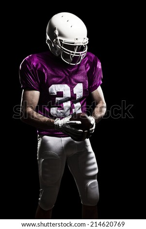 Football Player on a pink uniform, on a black background.