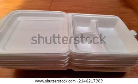 white styrofoam visible from the side. against a wooden table background. food packaging background concept, package, business, finance, lifestyle, cutlery, traditional market